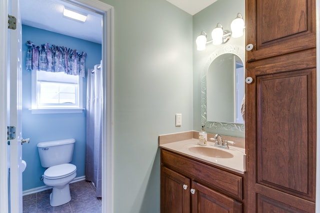 bathroom featuring toilet, vanity, and tile patterned floors