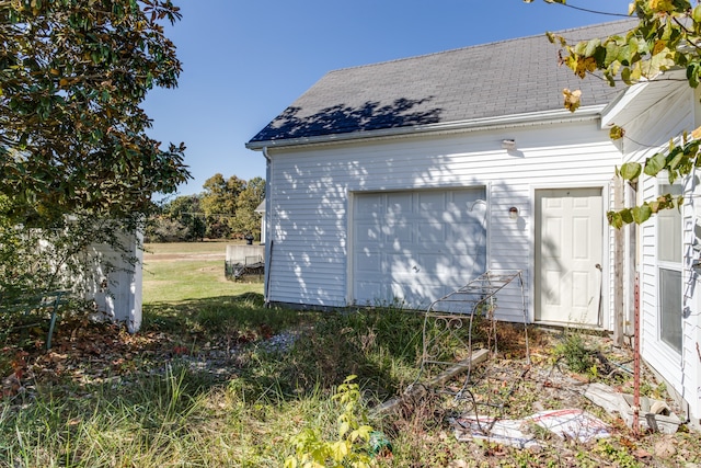 view of property exterior featuring an outbuilding and a garage