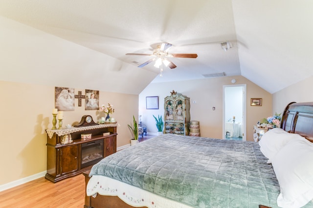 bedroom featuring ceiling fan, hardwood / wood-style flooring, and vaulted ceiling