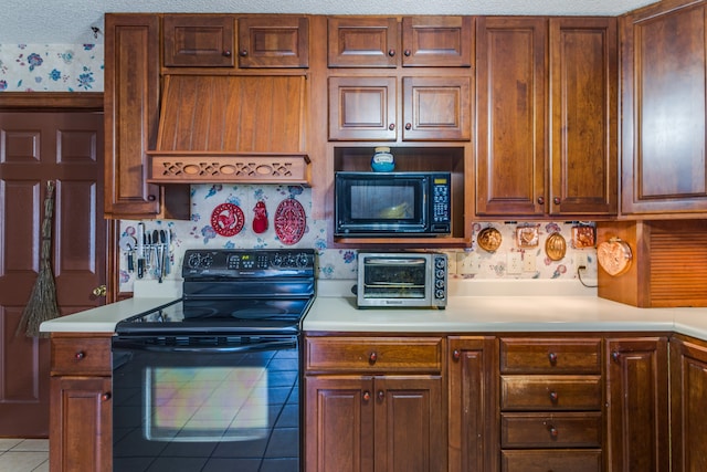 kitchen with tile patterned flooring, black appliances, a textured ceiling, and custom exhaust hood