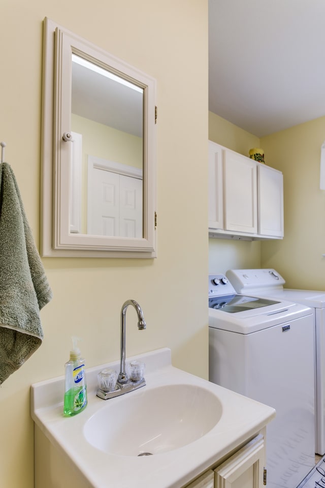 bathroom featuring vanity and independent washer and dryer