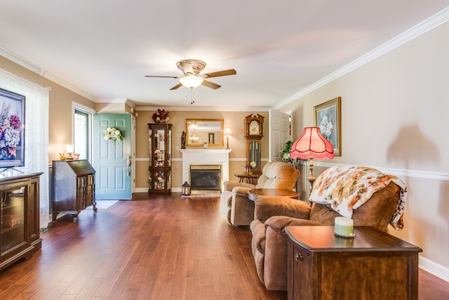 living room with ornamental molding, dark hardwood / wood-style floors, and ceiling fan