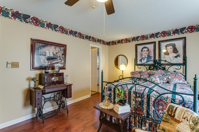 bedroom featuring dark hardwood / wood-style flooring, a textured ceiling, and ceiling fan