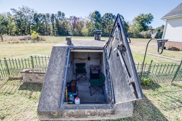 entry to storm shelter featuring a lawn