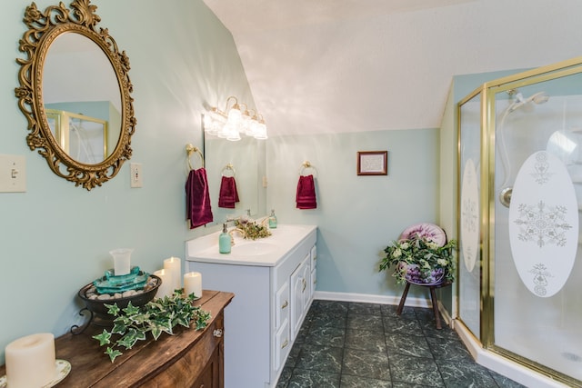 bathroom with vanity, a shower with shower door, and lofted ceiling