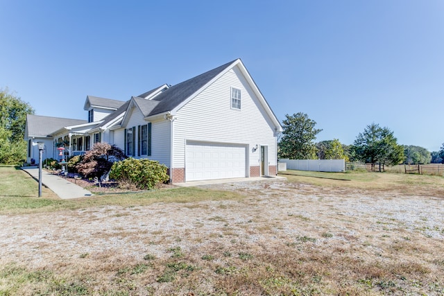 view of side of home with a garage and a lawn