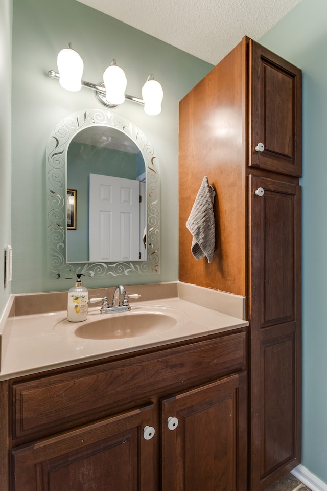 bathroom with vanity and a textured ceiling