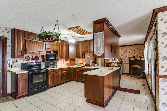 kitchen with light tile patterned floors, ceiling fan, a textured ceiling, black appliances, and sink