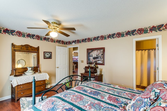 bedroom with ceiling fan, hardwood / wood-style flooring, and a textured ceiling