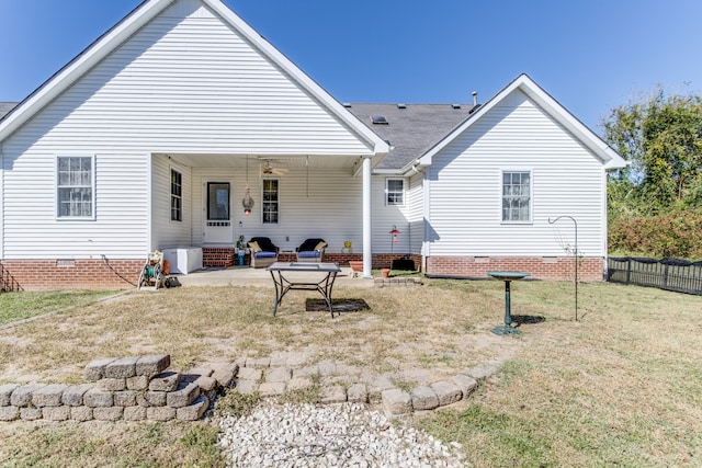 rear view of property featuring a patio, ceiling fan, and a lawn