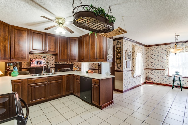 kitchen with kitchen peninsula, sink, black appliances, decorative light fixtures, and a textured ceiling