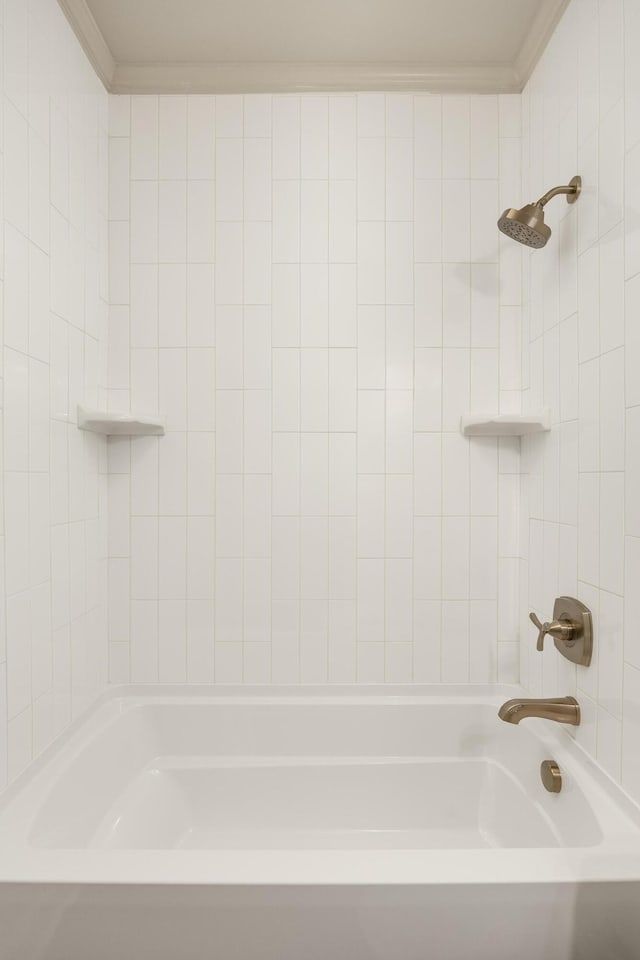 bathroom featuring ornamental molding and tiled shower / bath combo