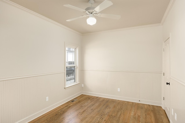 unfurnished room featuring crown molding, hardwood / wood-style floors, and ceiling fan