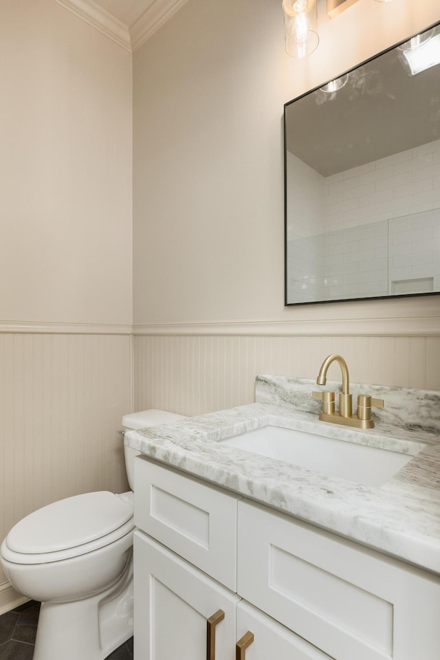 bathroom with vanity, crown molding, toilet, and tile patterned floors