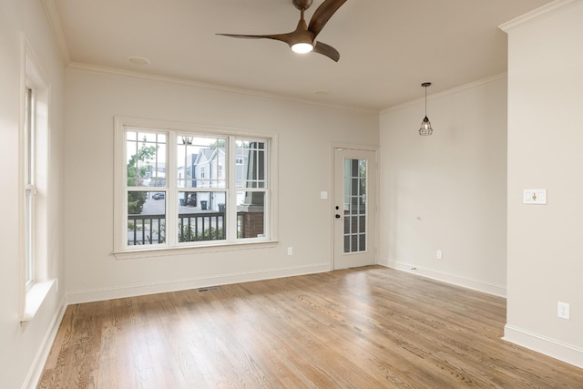 spare room with crown molding, light hardwood / wood-style flooring, and ceiling fan