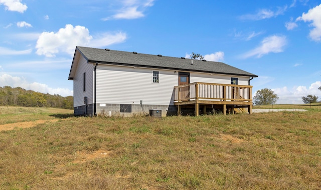 rear view of house featuring cooling unit and a deck