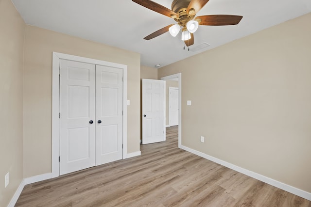 unfurnished bedroom with a closet, ceiling fan, and light wood-type flooring