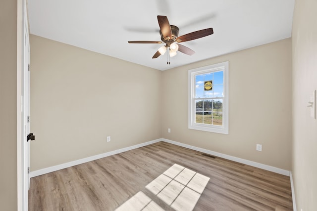 empty room featuring ceiling fan and light hardwood / wood-style flooring