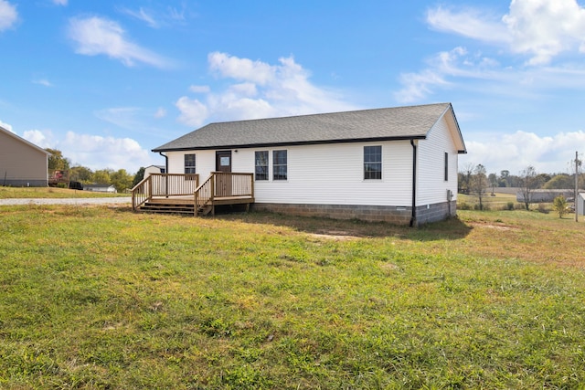 manufactured / mobile home with a front yard and a wooden deck