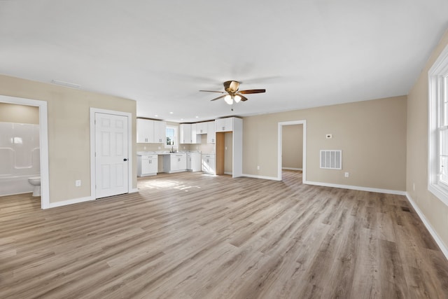 unfurnished living room with light hardwood / wood-style floors and ceiling fan