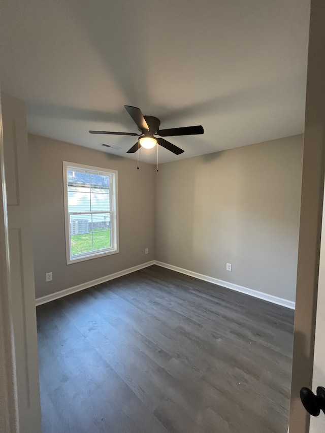 unfurnished room with ceiling fan and dark hardwood / wood-style floors