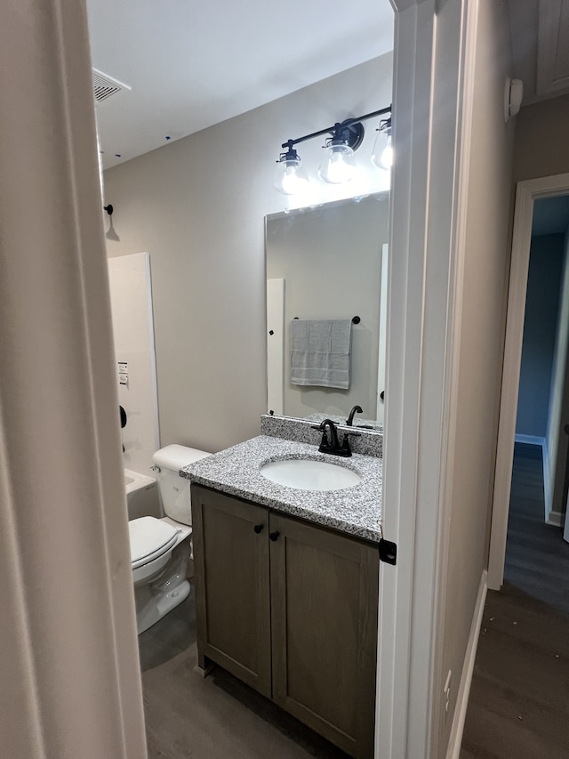 bathroom with vanity, wood-type flooring, and toilet