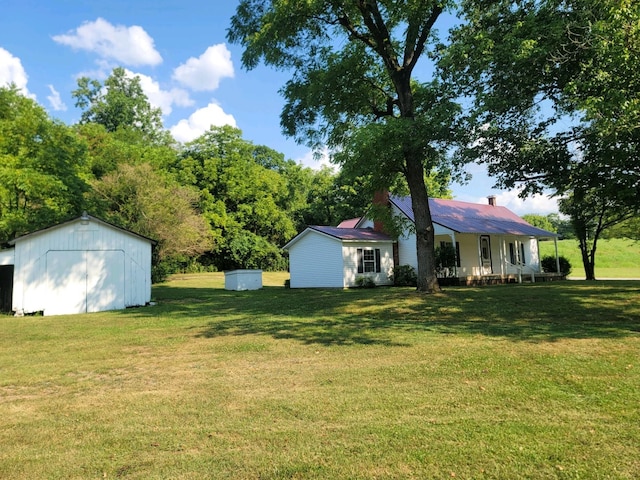 view of yard featuring a storage unit and a porch