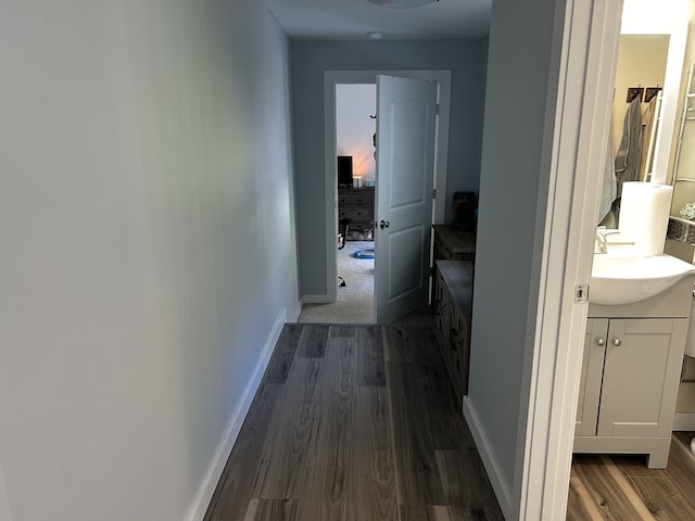 hall featuring sink and dark hardwood / wood-style flooring