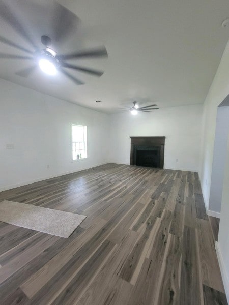 unfurnished living room featuring dark hardwood / wood-style flooring