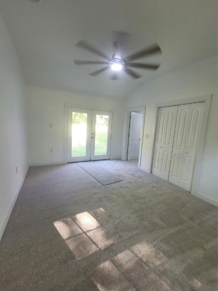 empty room featuring french doors, ceiling fan, and carpet