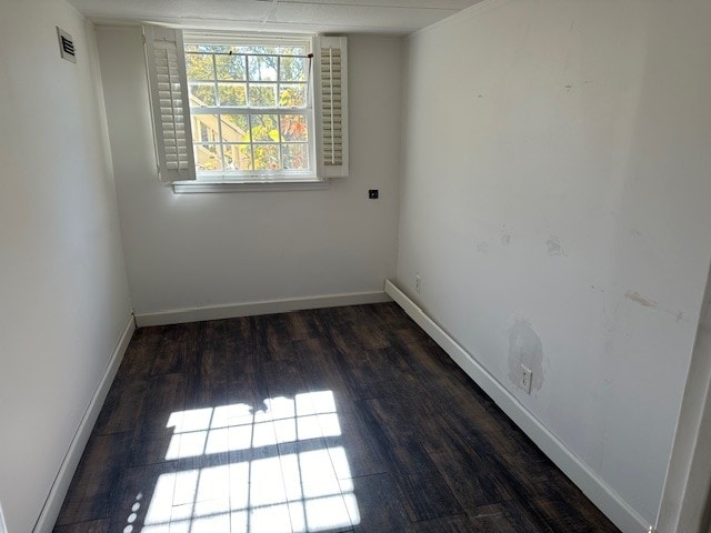 unfurnished room with dark wood-type flooring