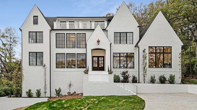 view of front of property featuring french doors and a balcony