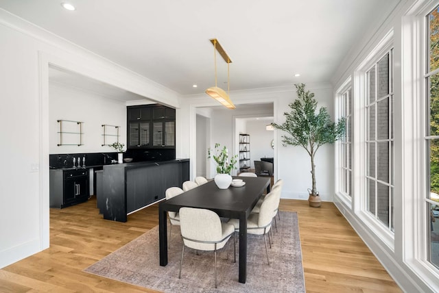 dining room with hardwood / wood-style flooring and ornamental molding