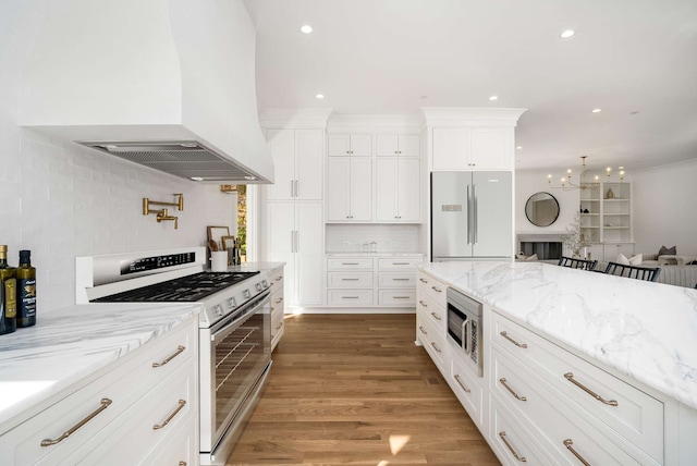 kitchen with dark wood-type flooring, stainless steel appliances, tasteful backsplash, white cabinets, and custom exhaust hood