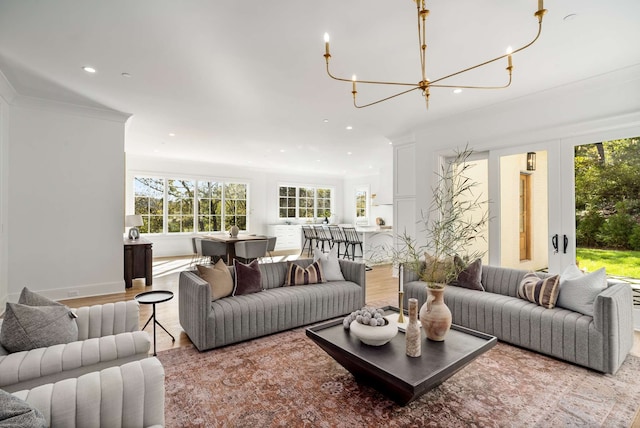 living room featuring ornamental molding and light hardwood / wood-style flooring