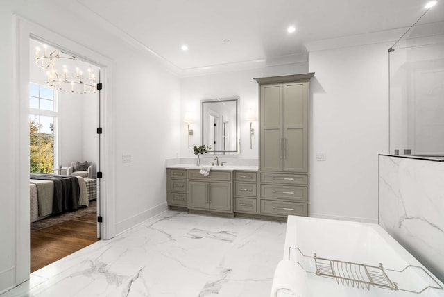 bathroom featuring hardwood / wood-style floors, vanity, an inviting chandelier, and ornamental molding