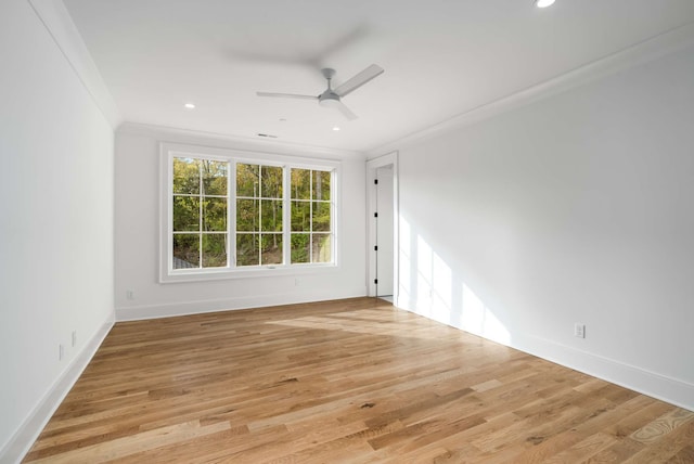 empty room featuring ceiling fan, light wood-type flooring, and ornamental molding