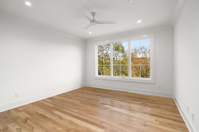 empty room with light wood-type flooring, ceiling fan, and ornamental molding