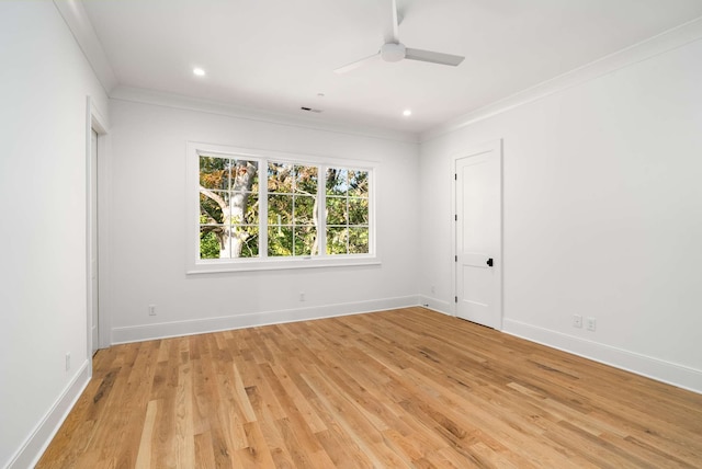 empty room with ceiling fan, ornamental molding, and light hardwood / wood-style flooring