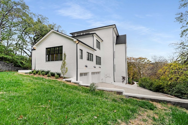 exterior space featuring a yard and a garage