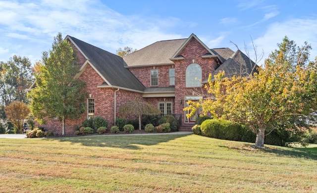 306 Gray Hawk Trl, Clarksville, TN 37043 - traditional-style home with roof with shingles, a front yard, and brick siding