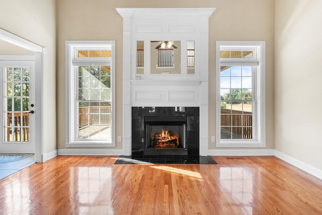 306 Gray Hawk Trl, Clarksville, TN 37043 - unfurnished living room with baseboards, wood finished floors, and a fireplace with flush hearth