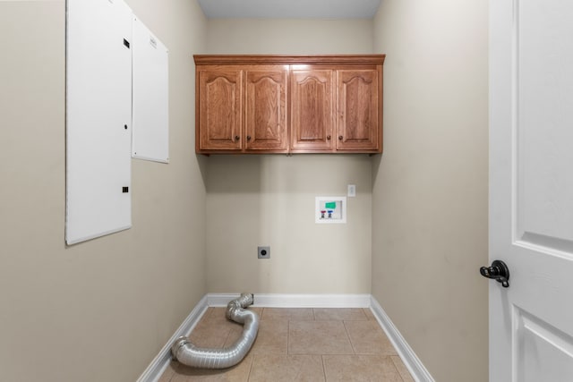 laundry area with hookup for an electric dryer, washer hookup, cabinets, and light tile patterned floors