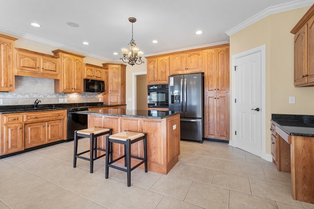 kitchen with tasteful backsplash, a kitchen island, a chandelier, ornamental molding, and black appliances