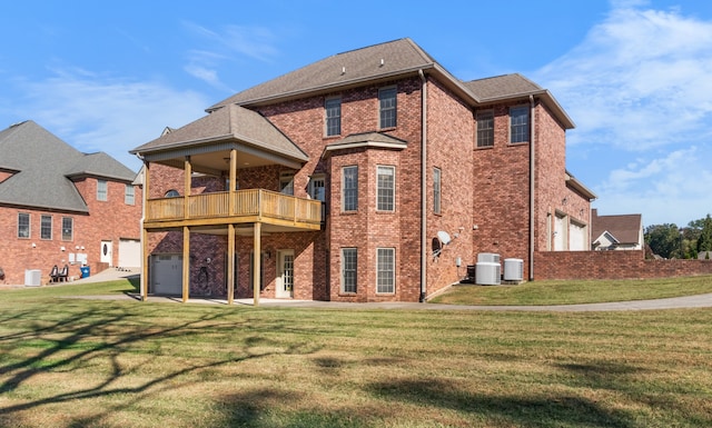 back of house featuring a balcony, cooling unit, and a lawn