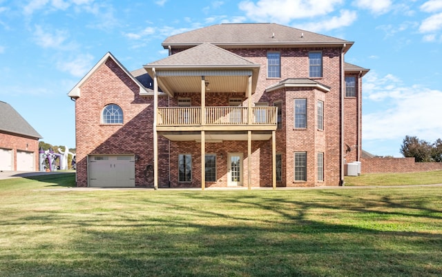 back of house featuring a balcony, a yard, and a garage