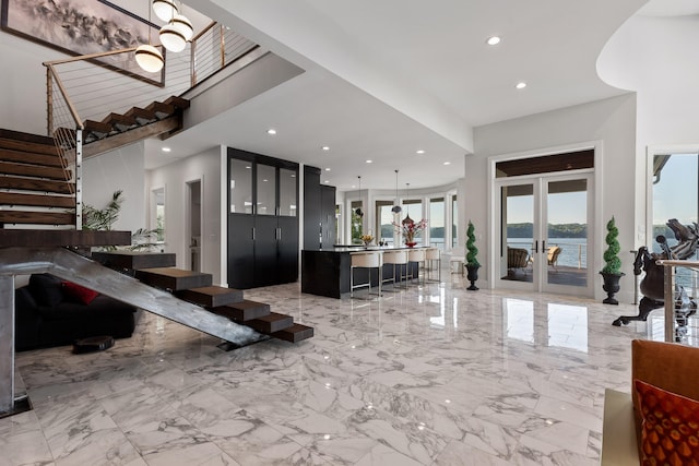 interior space featuring french doors and a water view