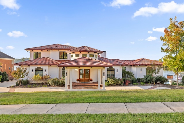 mediterranean / spanish-style home with a front lawn