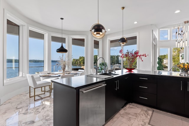 kitchen with a water view, sink, and plenty of natural light