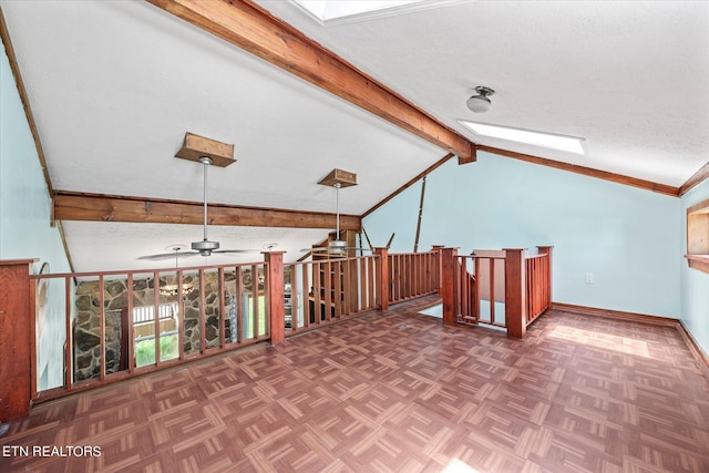 bonus room with lofted ceiling with skylight, ceiling fan, and baseboards